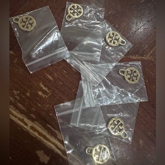 Tory Burch Jewelry - Six golden Tory Burch charms